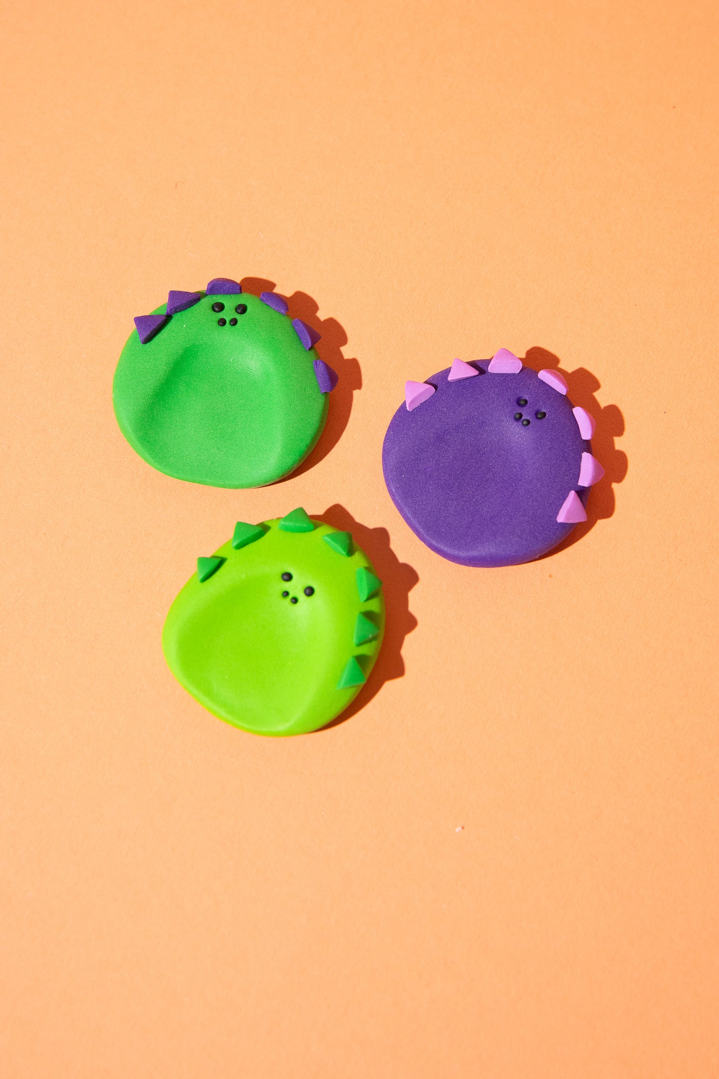 Grüner Dino-Sorgenstein aus Polymer Clay mit sensorischen Zacken zum Stimming und Fidgeting.